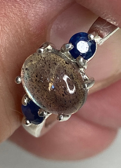 Sterling silver ring with oval labradorite and two blue sapphires.