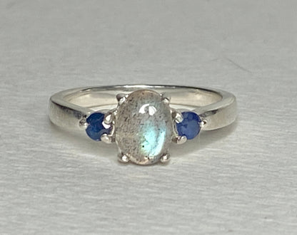 Sterling silver ring with oval labradorite and two blue sapphires.