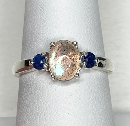 Sterling silver ring with oval labradorite and two round blue sapphires.