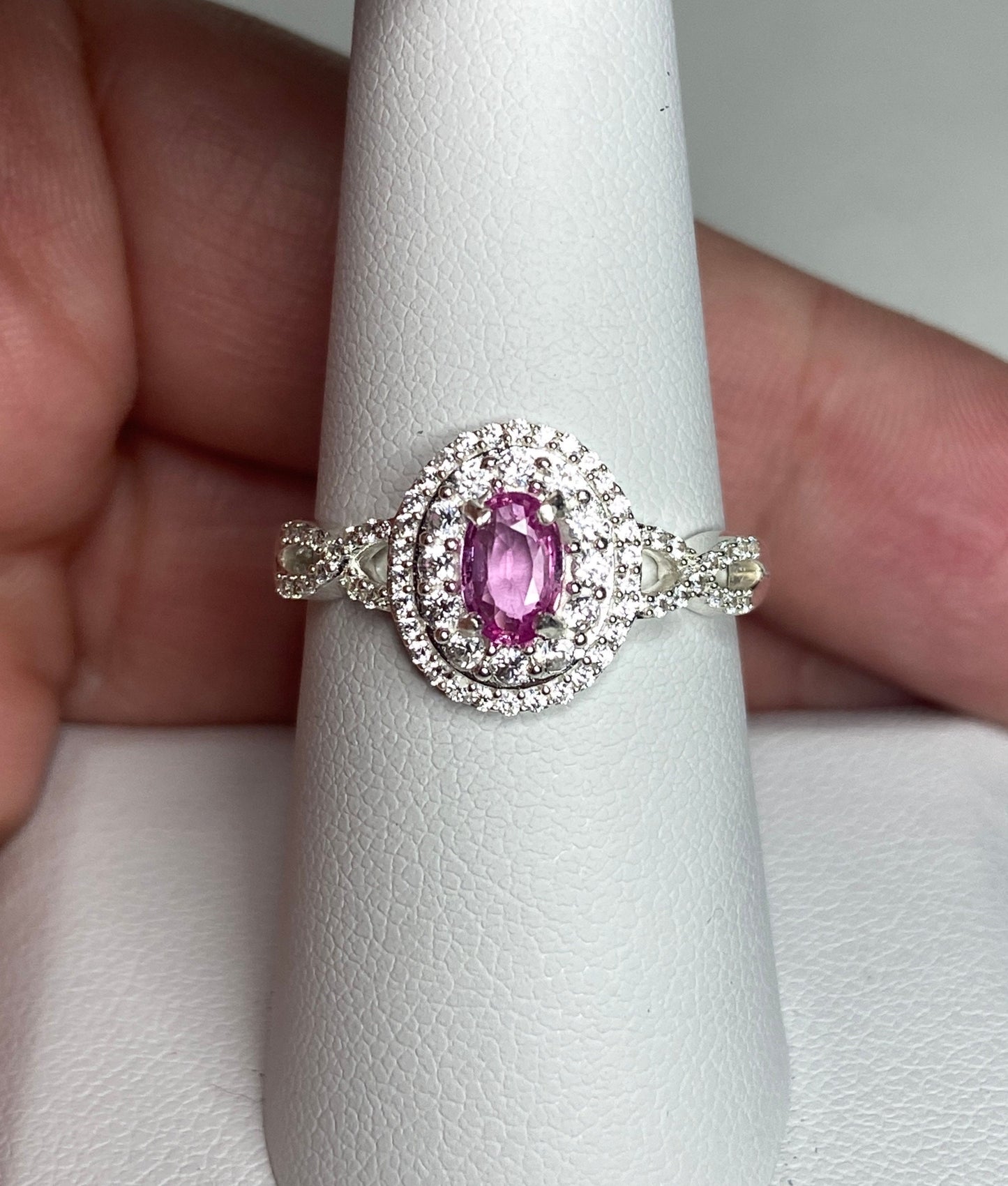 Oval pink sapphire ring with double zircon halo in sterling silver.