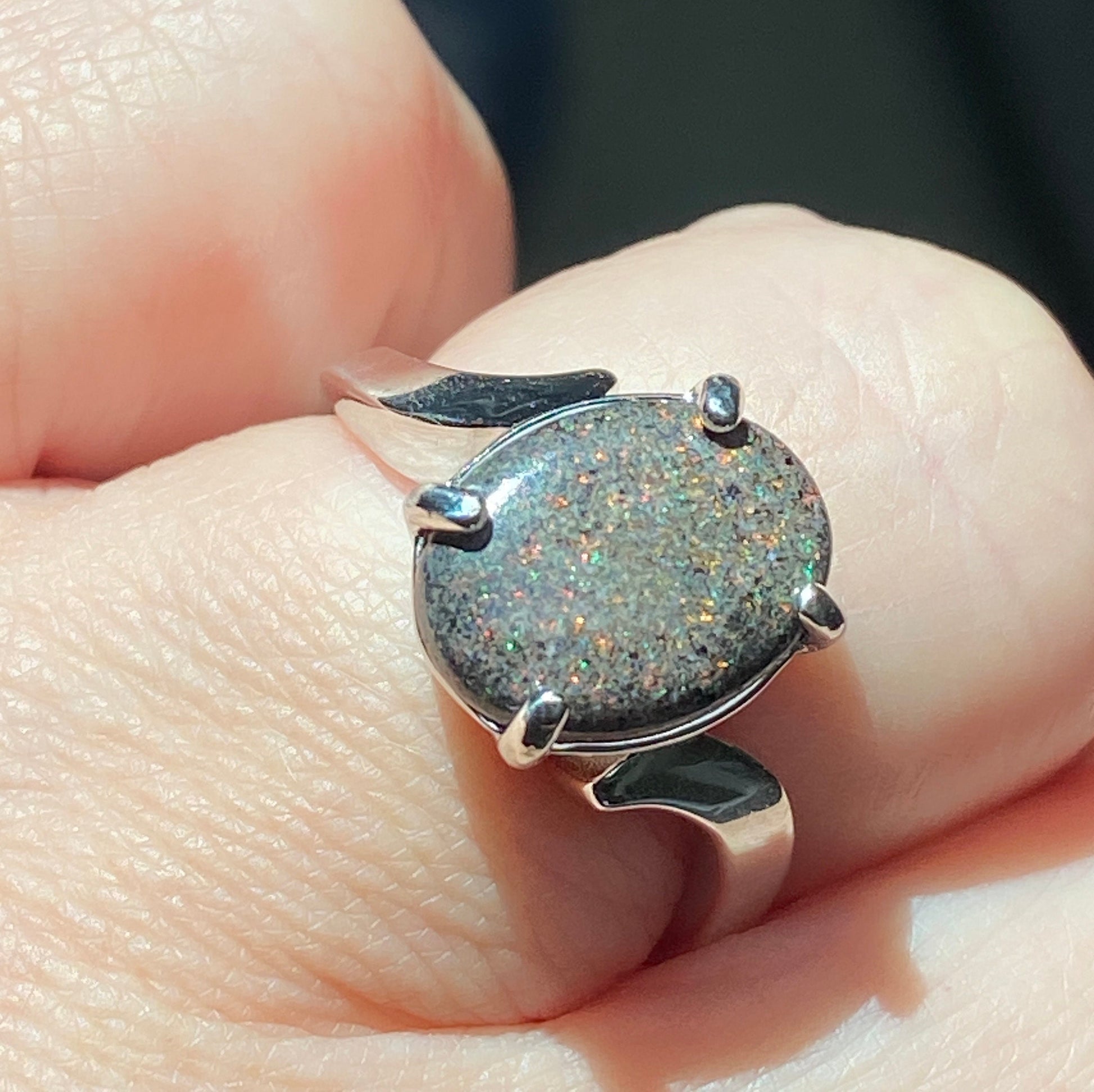 Sterling silver ring with a star-like pinfire boulder opal.