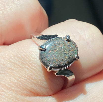 Sterling silver ring with a star-like pinfire boulder opal.
