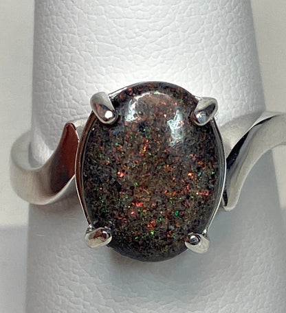 Sterling silver ring with a starry night pinfire boulder opal.