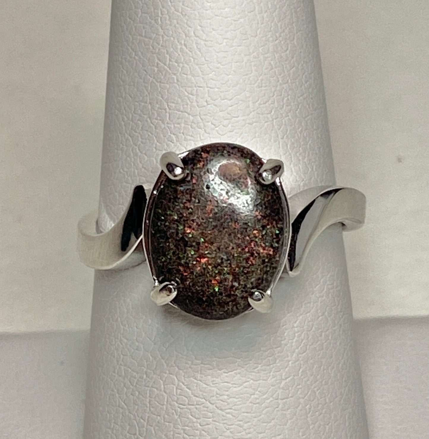 Oval pinfire boulder opal ring in sterling silver.