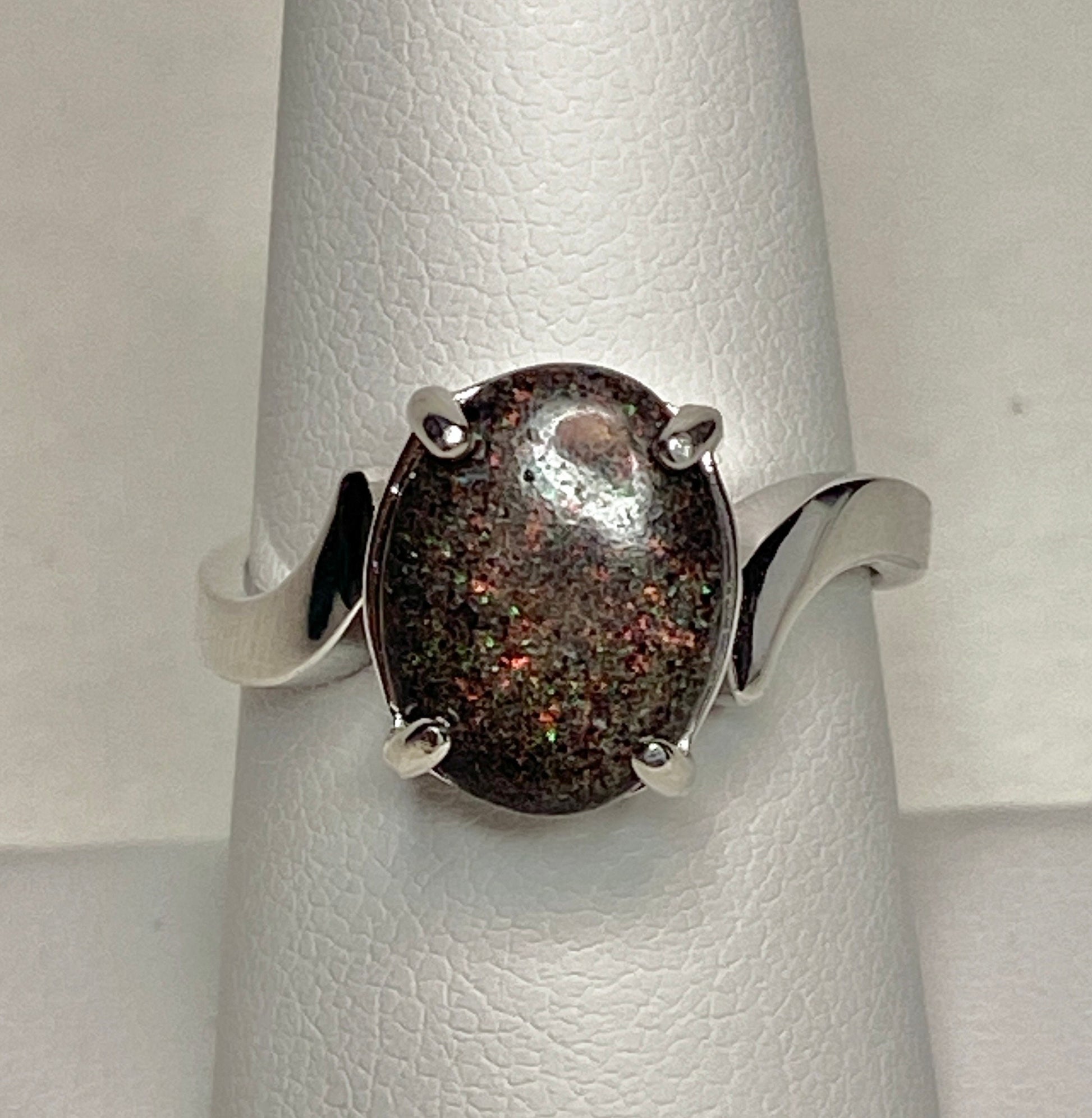 Oval pinfire boulder opal ring in sterling silver.