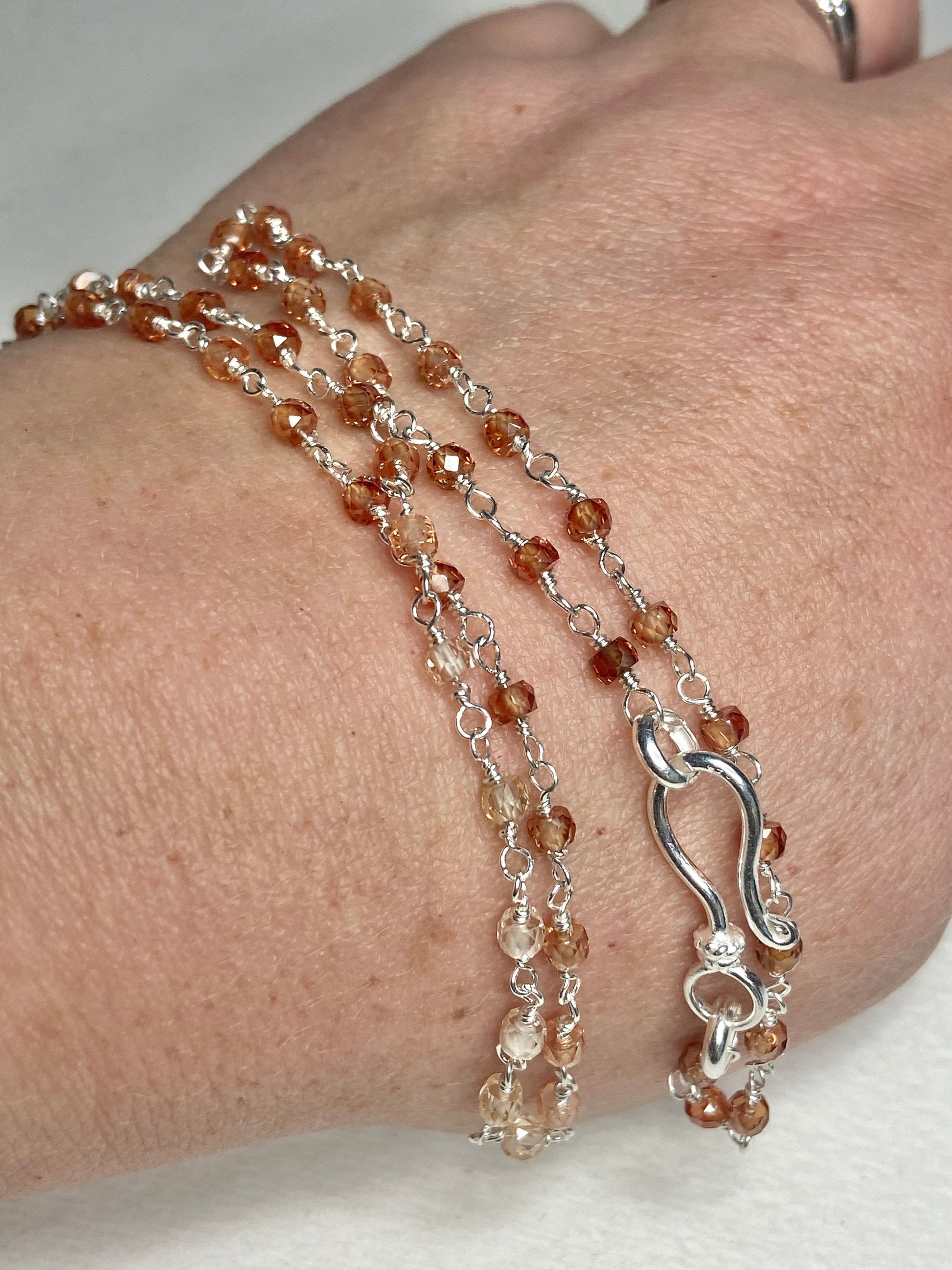 Sterling silver necklace with faceted brown ombre zircon beads and a hook clasp.