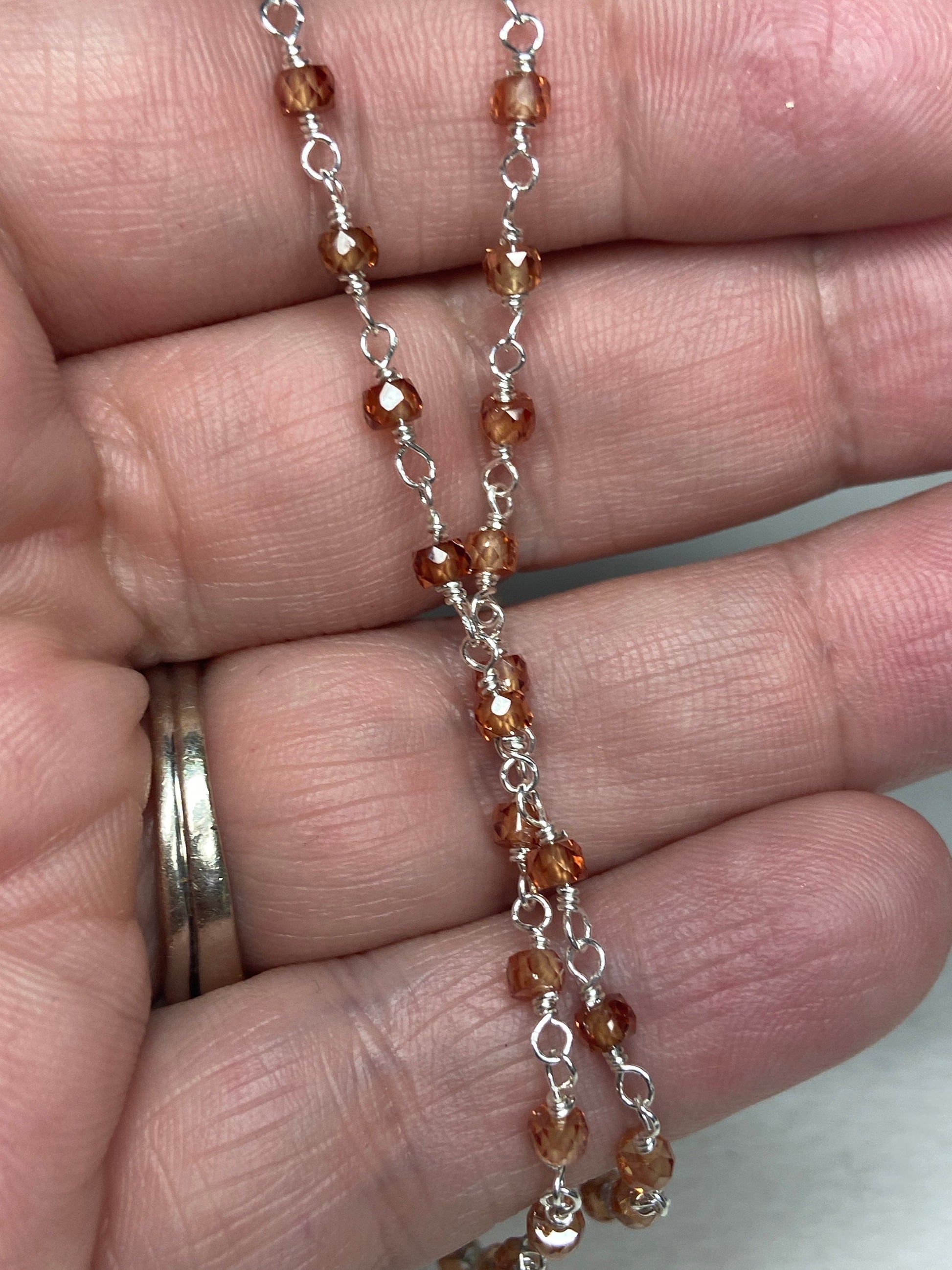 Sterling silver necklace with faceted brown zircon beads in an ombre pattern.