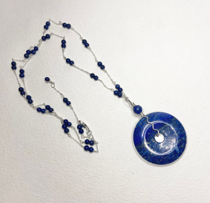 Lapis lazuli sterling silver donut pendant necklace with beaded chain.
