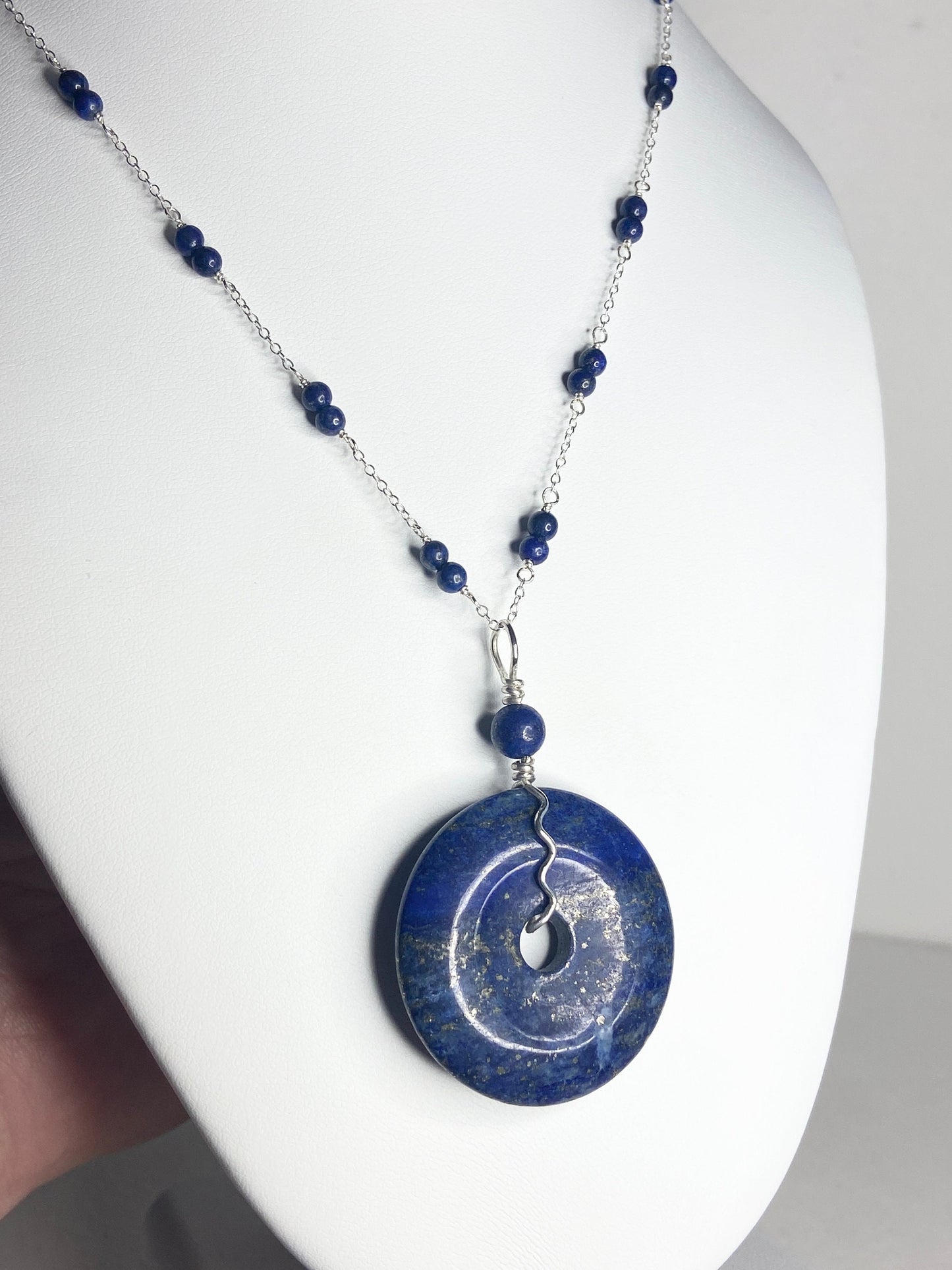 Lapis lazuli donut pendant necklace with sterling silver chain and beads.