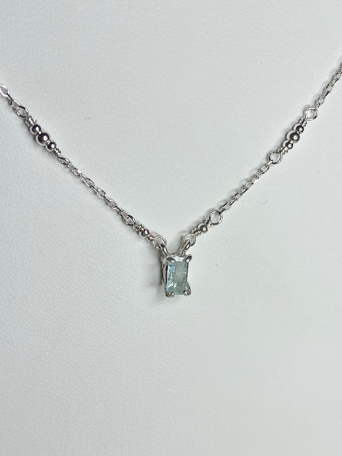 Sterling silver necklace with a rectangular cuprian tourmaline pendant.