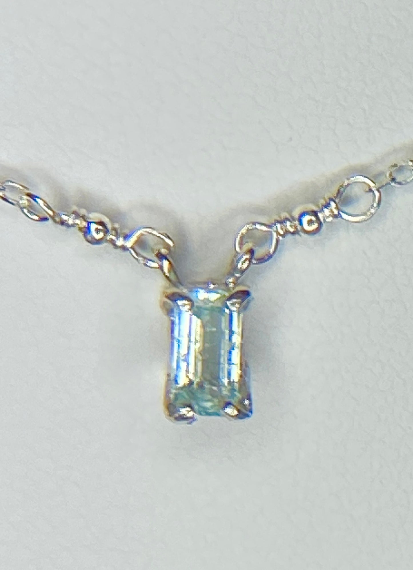 Sterling silver necklace with a rectangular cuprian tourmaline pendant.