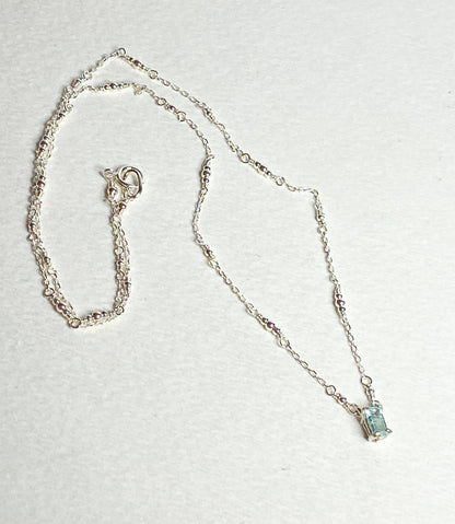 Sterling silver necklace with a rectangular cuprian tourmaline pendant.