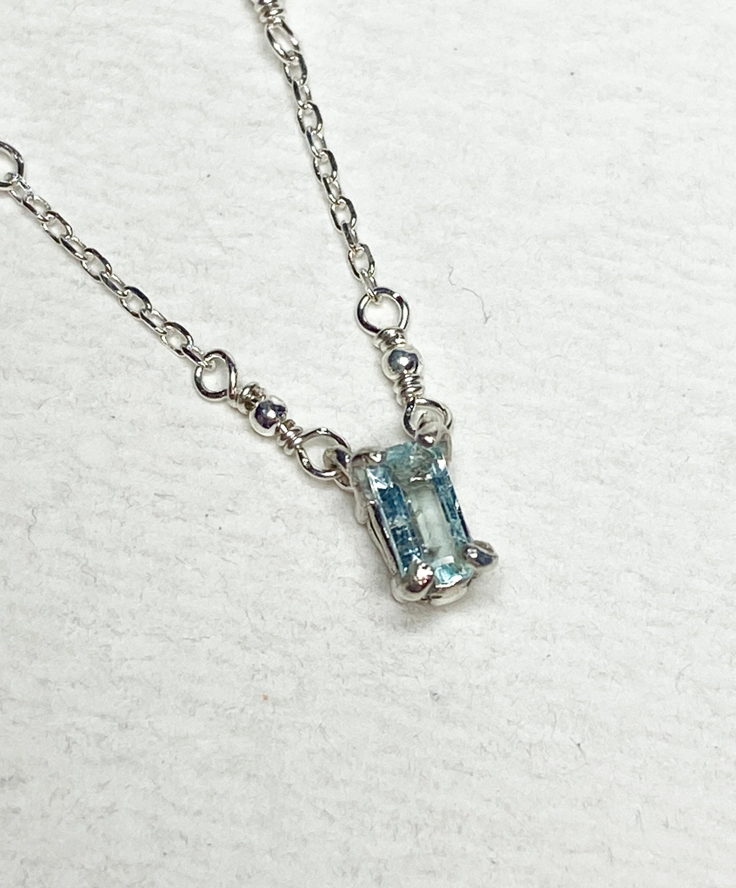 Sterling silver necklace with a rectangular cuprian tourmaline pendant.