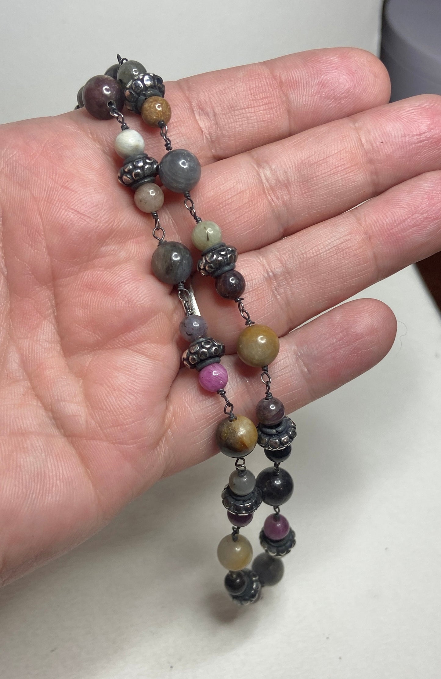 A multi-color sapphire corundum beaded necklace with sterling silver accents.