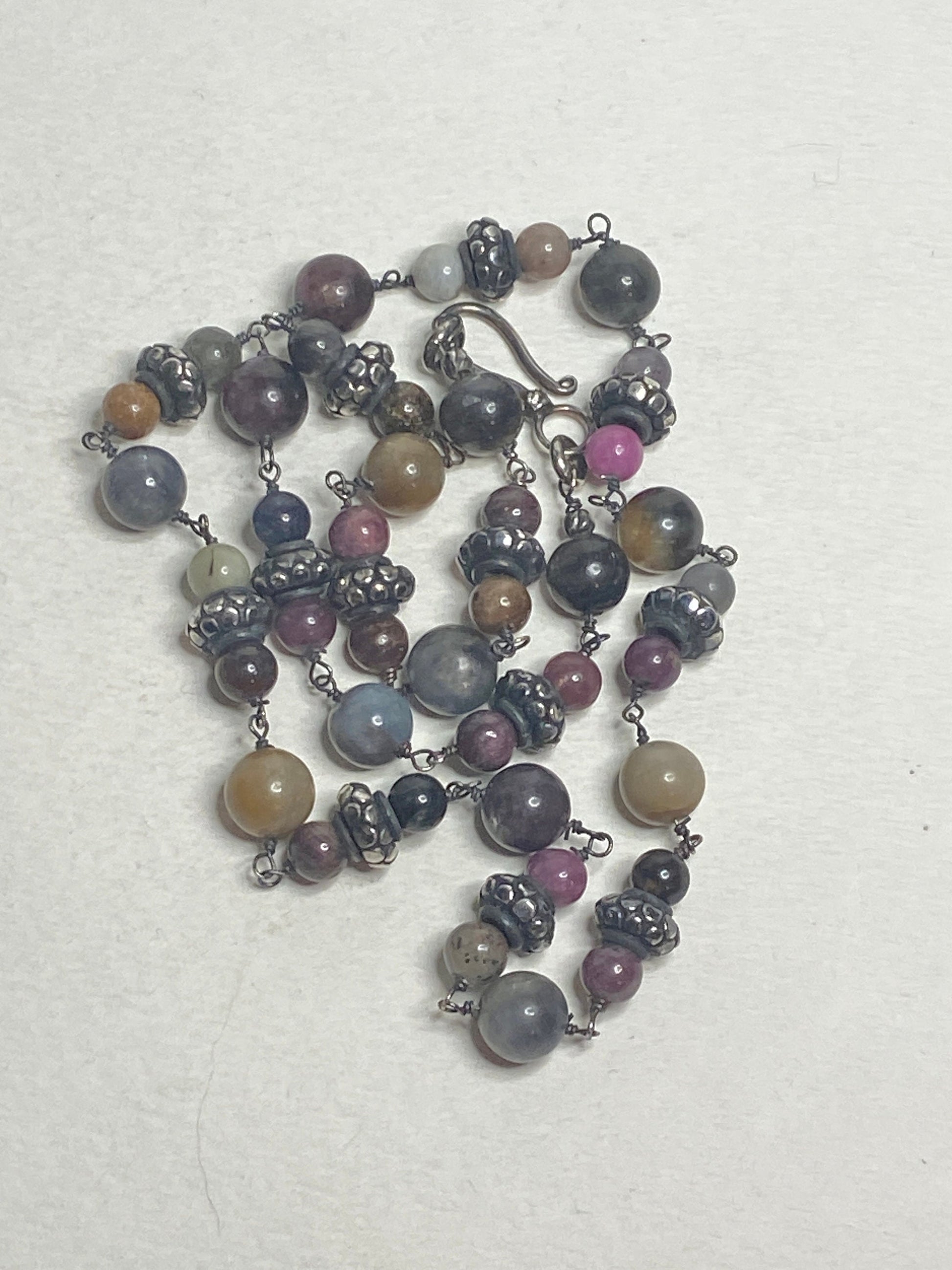 Natural multi-color sapphire corundum beaded necklace with sterling silver accents.