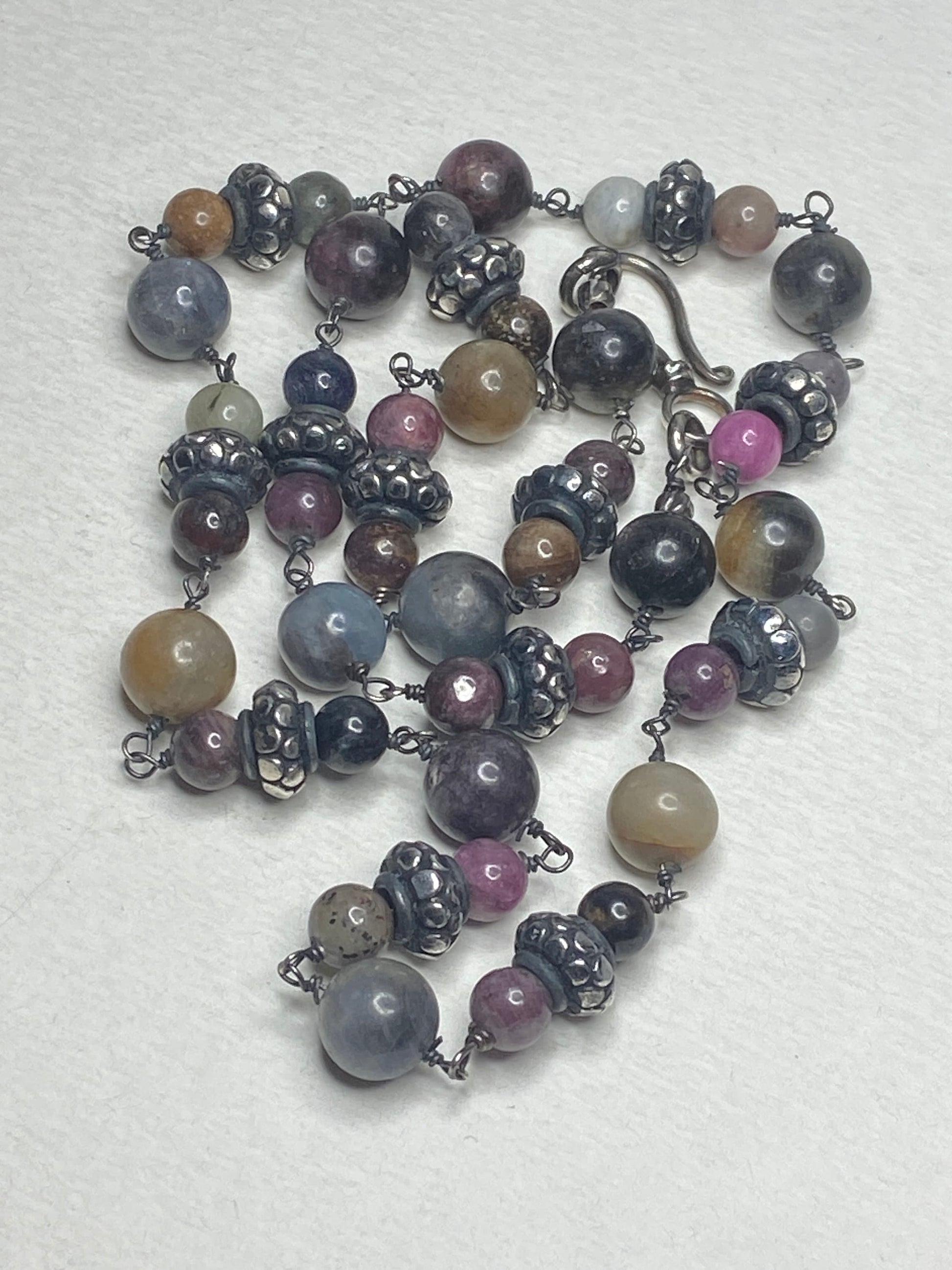 Natural multi-color sapphire corundum beaded necklace with sterling silver accents.