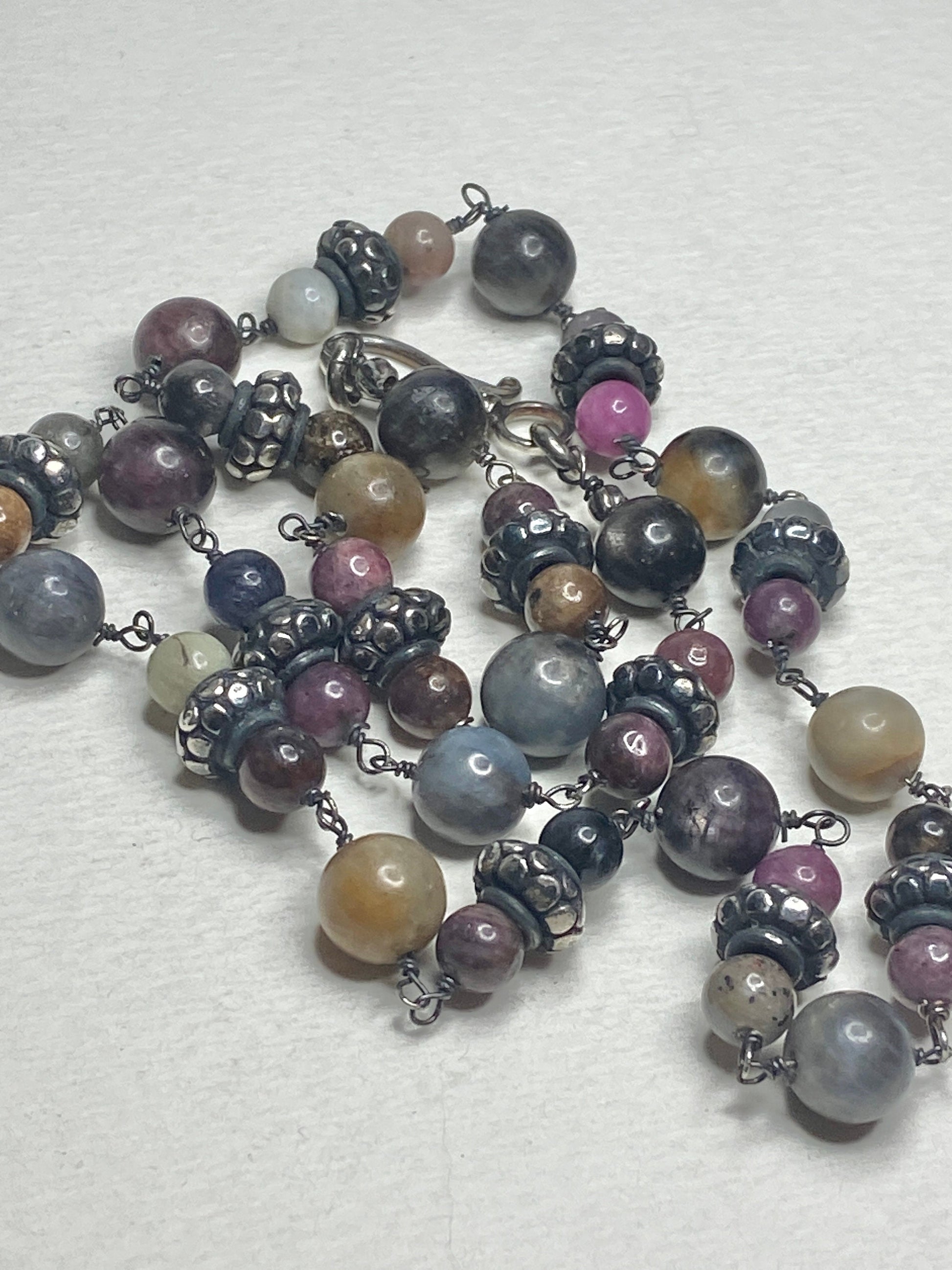Natural multi-color sapphire corundum beaded necklace with sterling silver accents.
