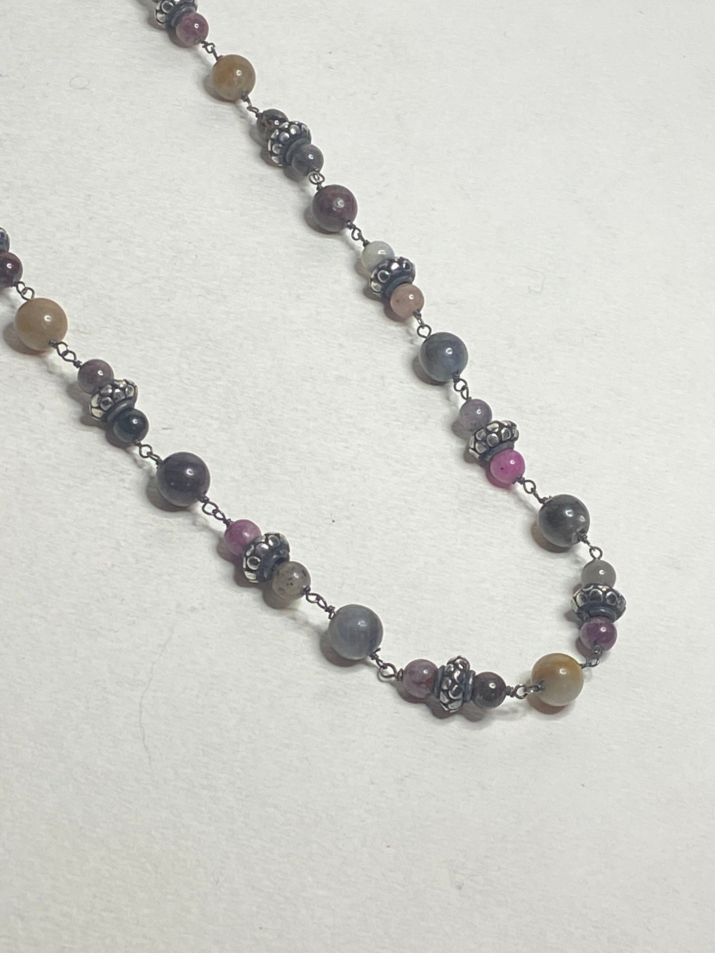 Natural multi-color sapphire corundum beaded necklace with sterling silver accents.