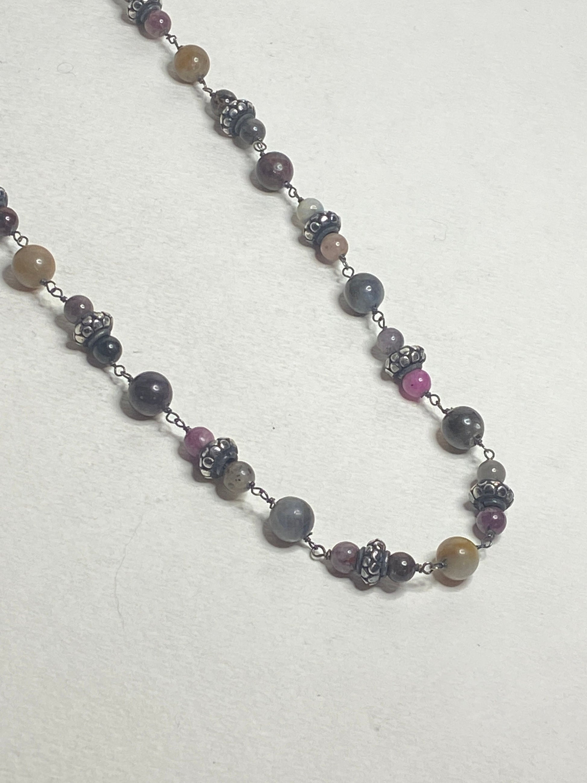 Natural multi-color sapphire corundum beaded necklace with sterling silver accents.