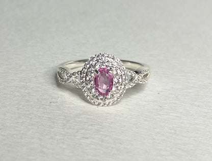 Oval pink sapphire ring with double zircon halo in sterling silver.