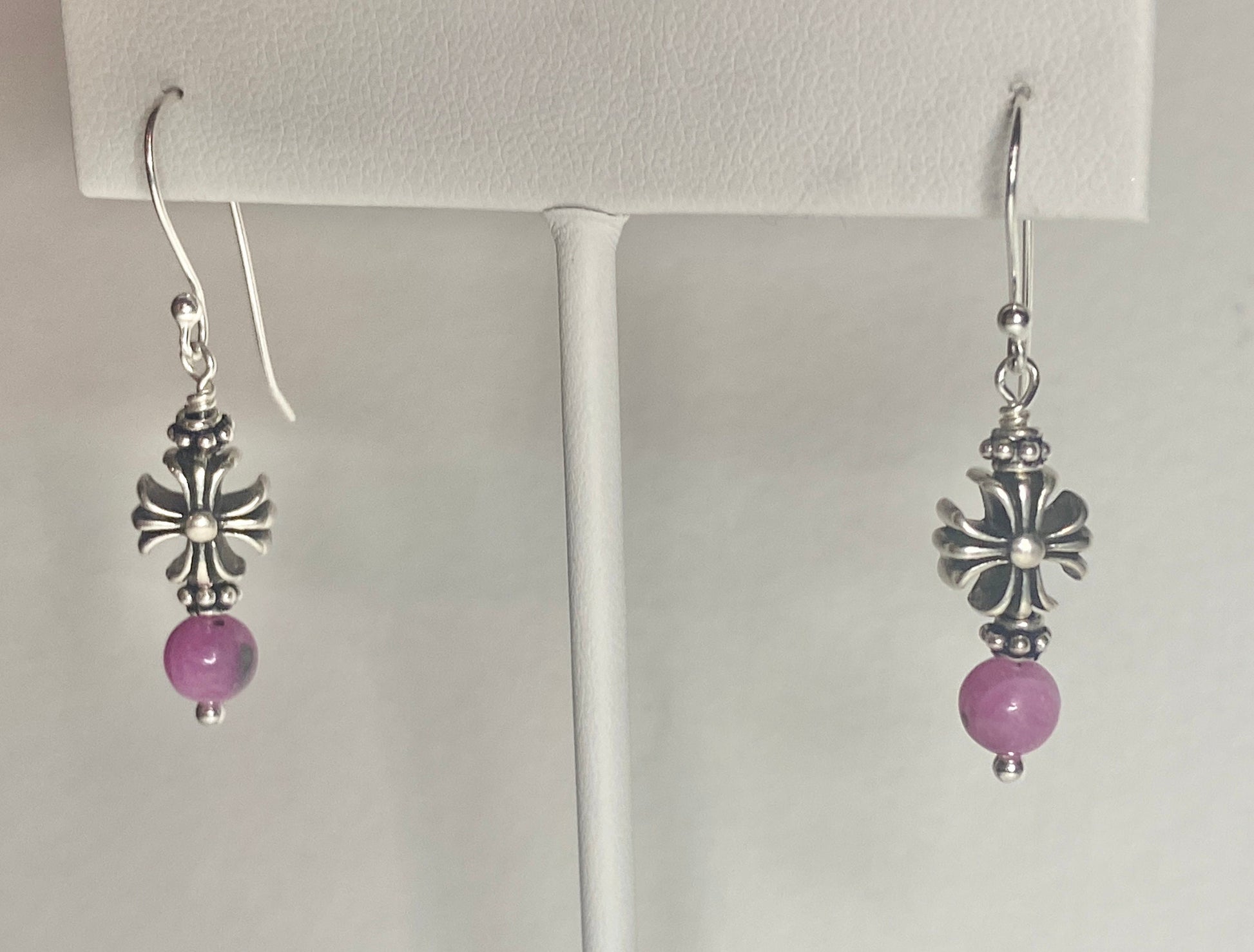 Sterling silver dangle earrings with pink sapphire beads and cross charms.