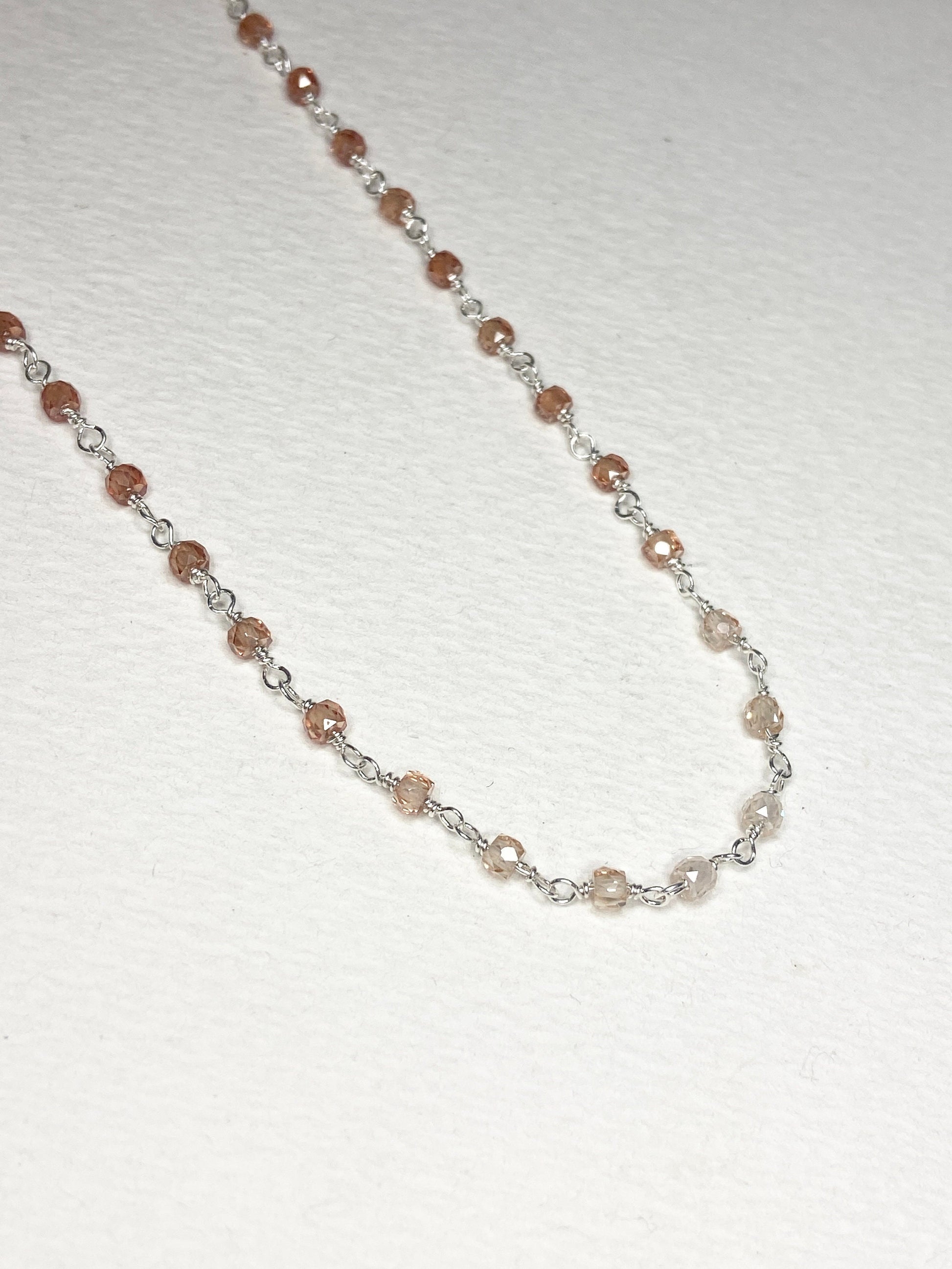 Sterling silver necklace with faceted brown zircon beads in an ombre pattern.