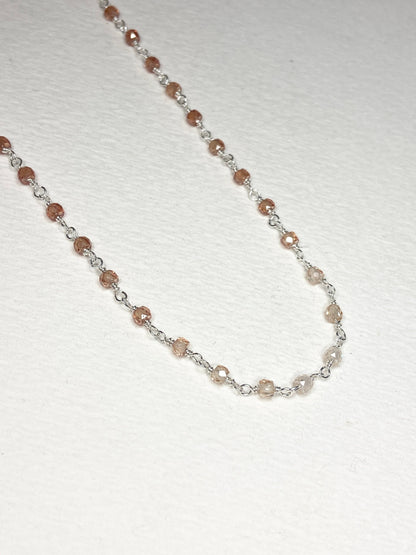 Sterling silver necklace with faceted brown zircon beads in an ombre pattern.