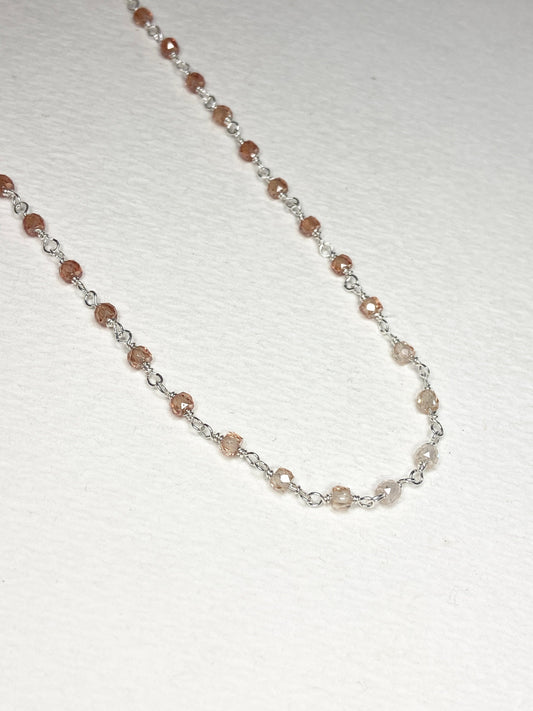 Sterling silver necklace with faceted brown zircon beads in an ombre pattern.