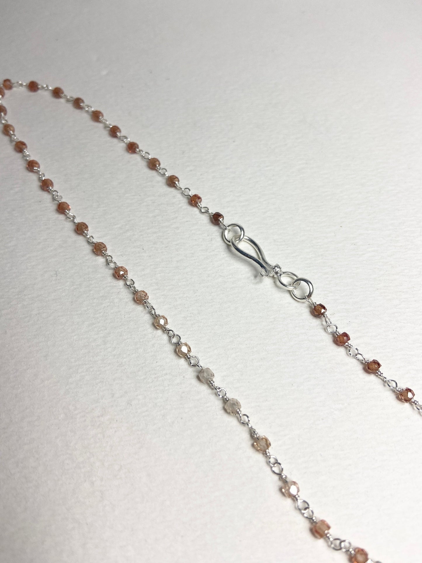 Sterling silver necklace with faceted brown ombre zircon beads and a hook clasp.