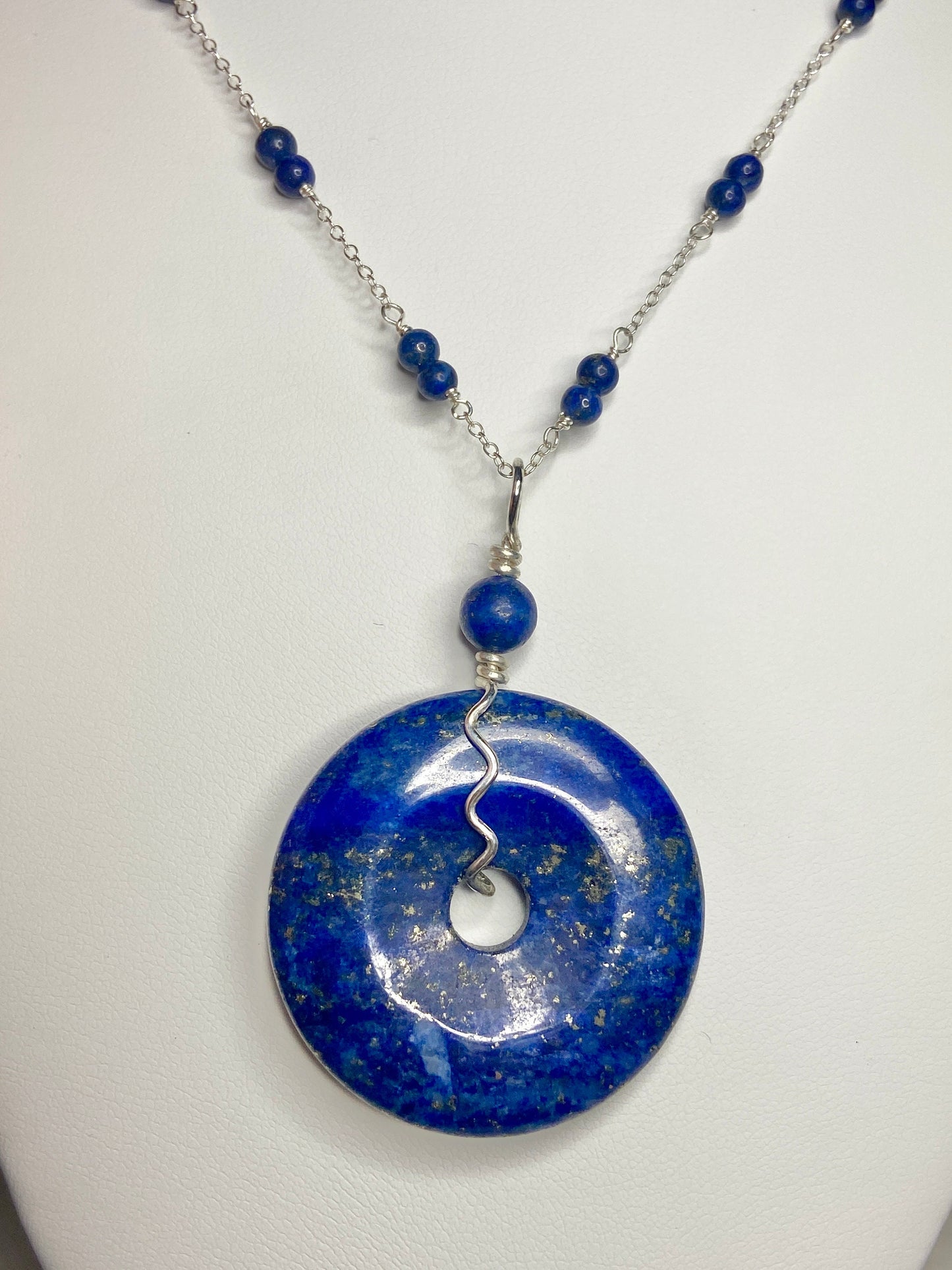 Lapis lazuli donut pendant necklace with sterling silver chain and beads.