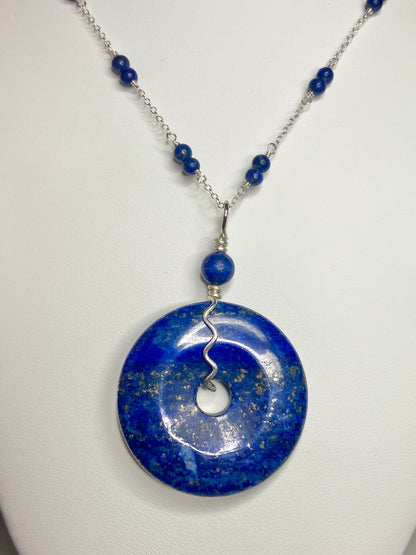 Lapis lazuli donut pendant necklace with sterling silver chain and beads.