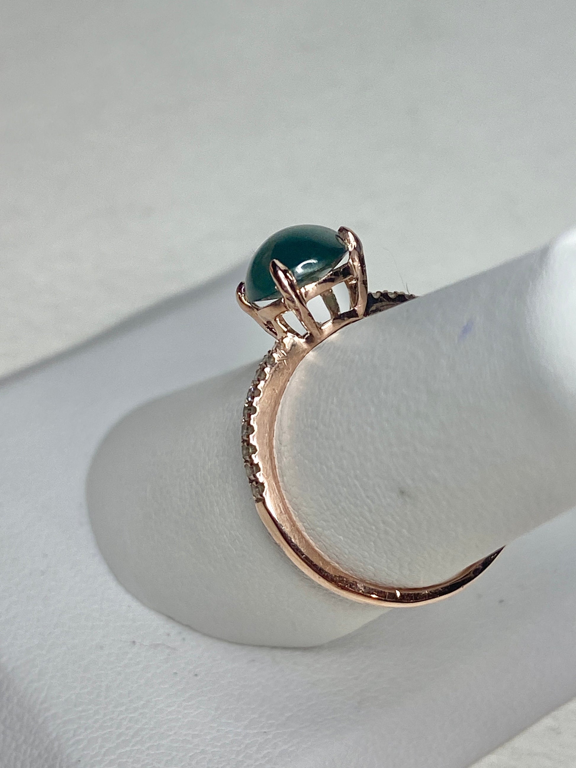 A teal jadeite and diamond ring in 14k rose gold.