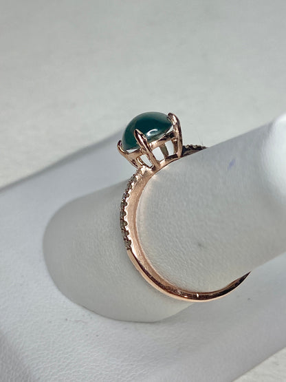 A teal jadeite and diamond ring in 14k rose gold.