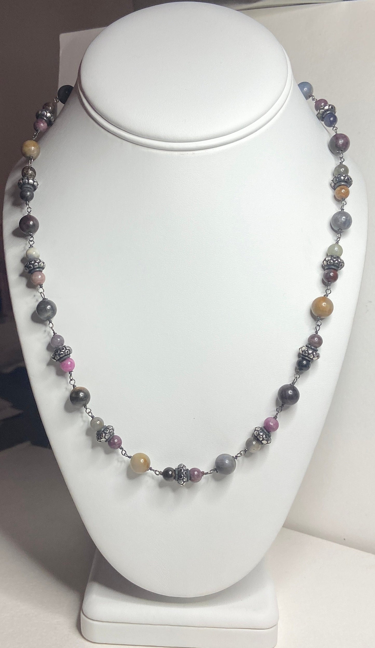 Natural multi-color sapphire corundum beaded necklace with sterling silver accents.