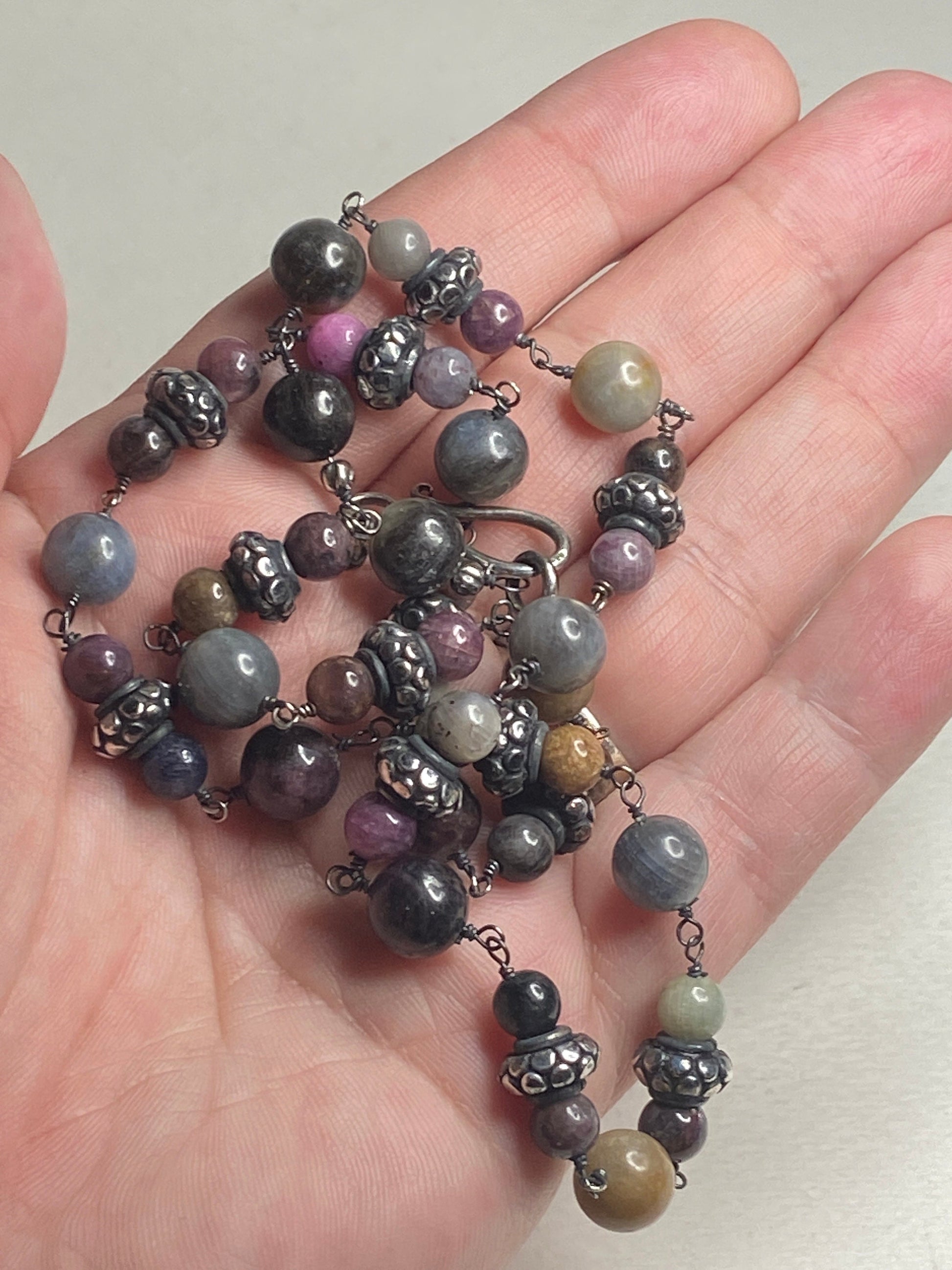 Natural multi-color sapphire corundum beaded necklace with sterling silver accents.