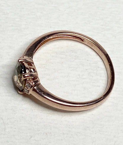 10k rose gold ring with a natural zircon and diamonds.