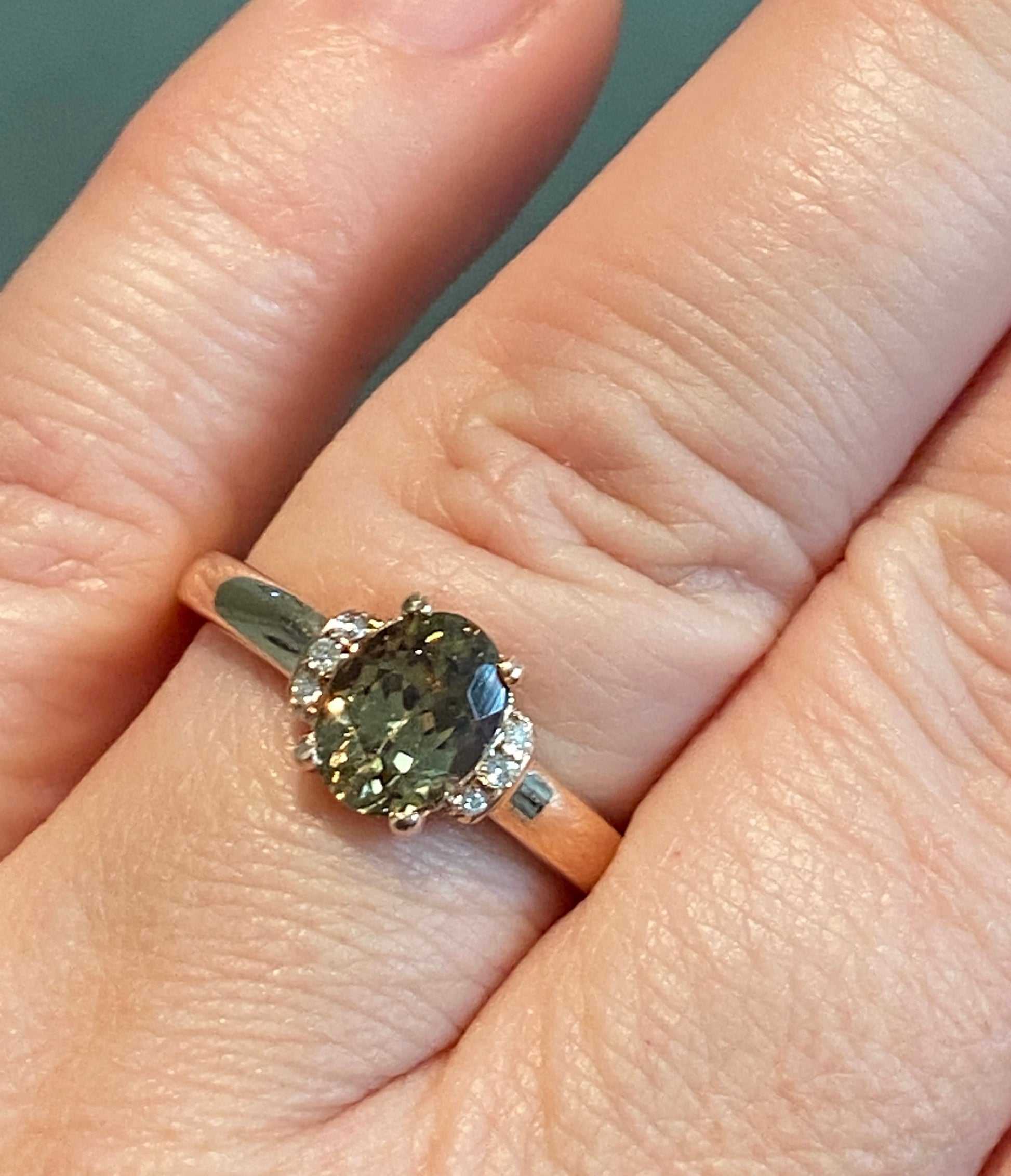 Oval green zircon and diamond ring in 10k rose gold.