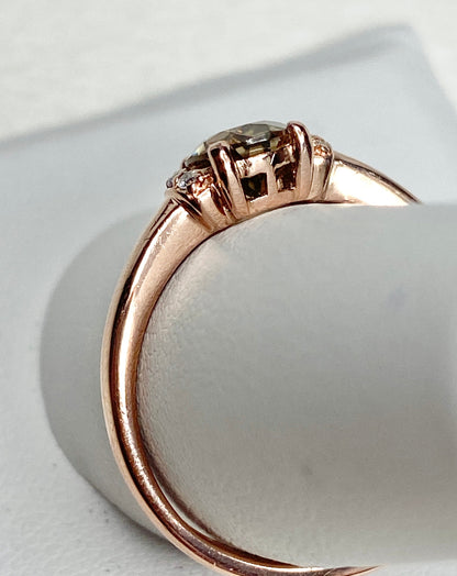10k rose gold ring with a natural green-gold zircon and diamonds.