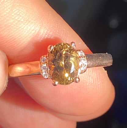 Oval greenish-gold zircon and diamond ring in 10k rose gold.