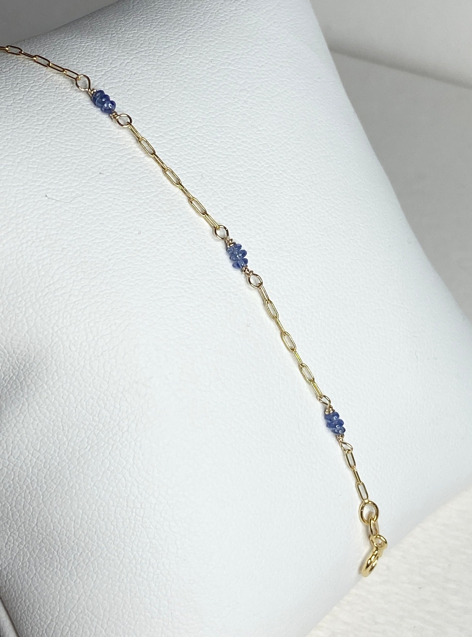 A 14k gold paperclip chain bracelet with untreated violet-blue Burmese sapphire beads.