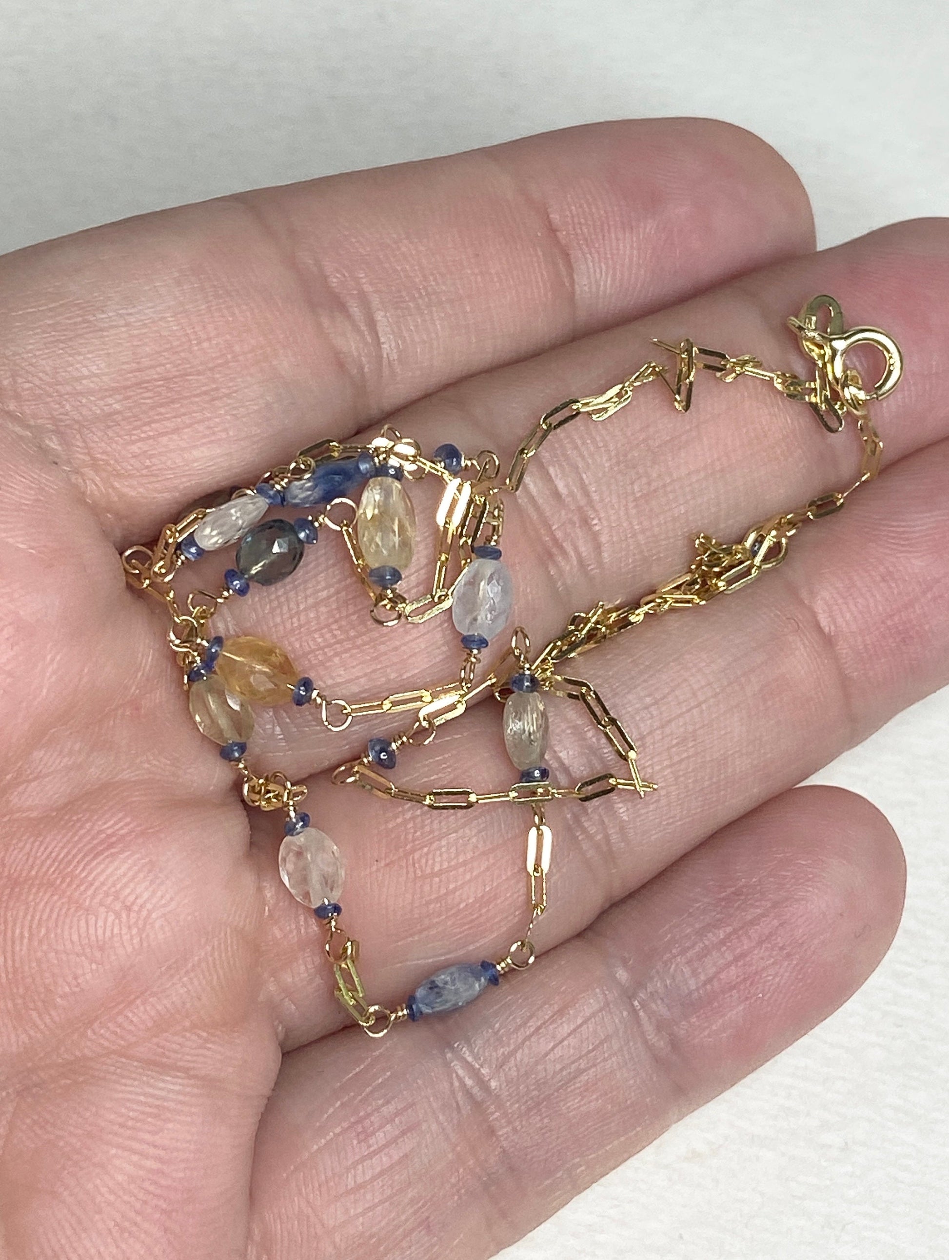 14k gold station chain necklace with multi-color untreated sapphires.