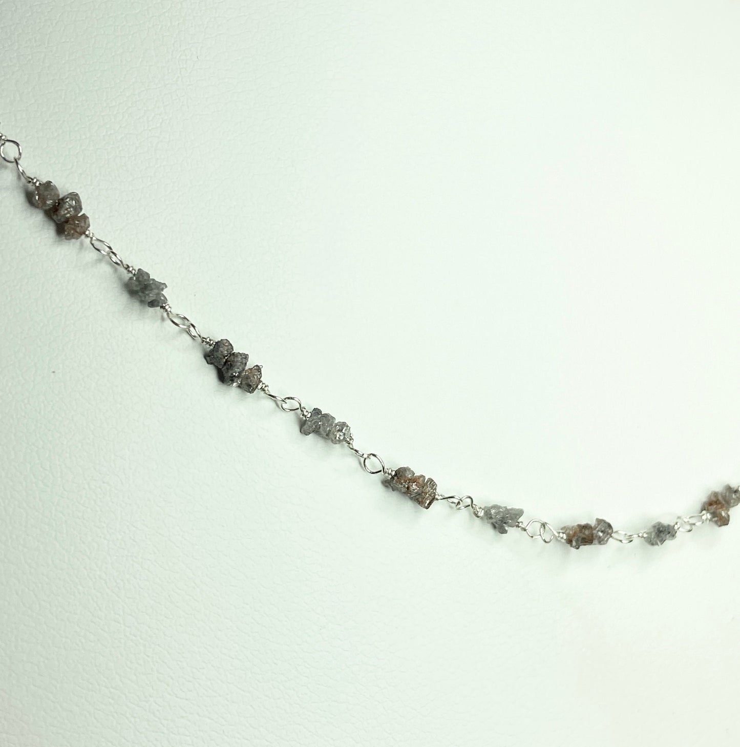 Sterling silver necklace with stations of rough natural silver and brown diamonds.