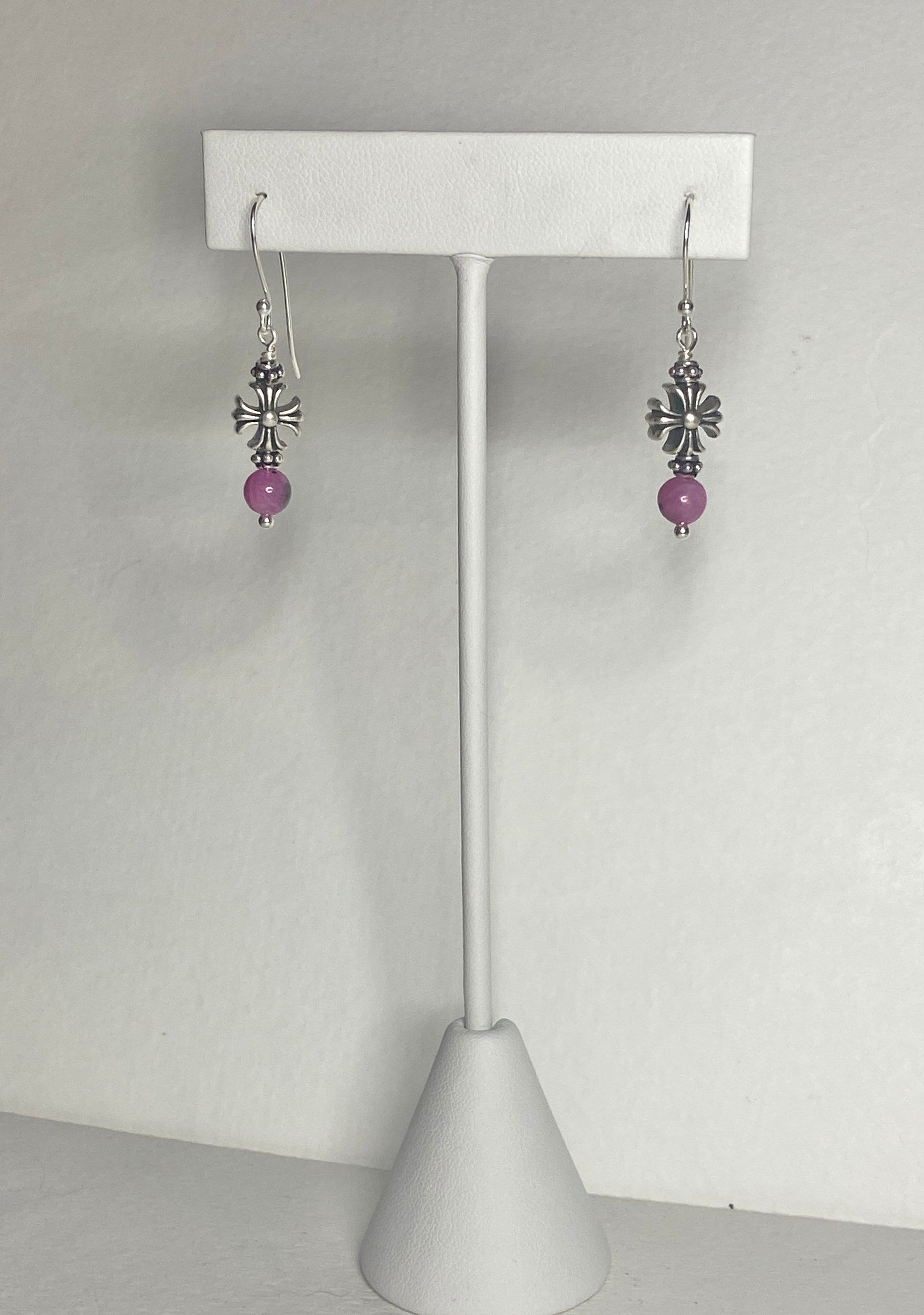 Sterling silver dangle earrings with pink sapphire beads and cross charms.