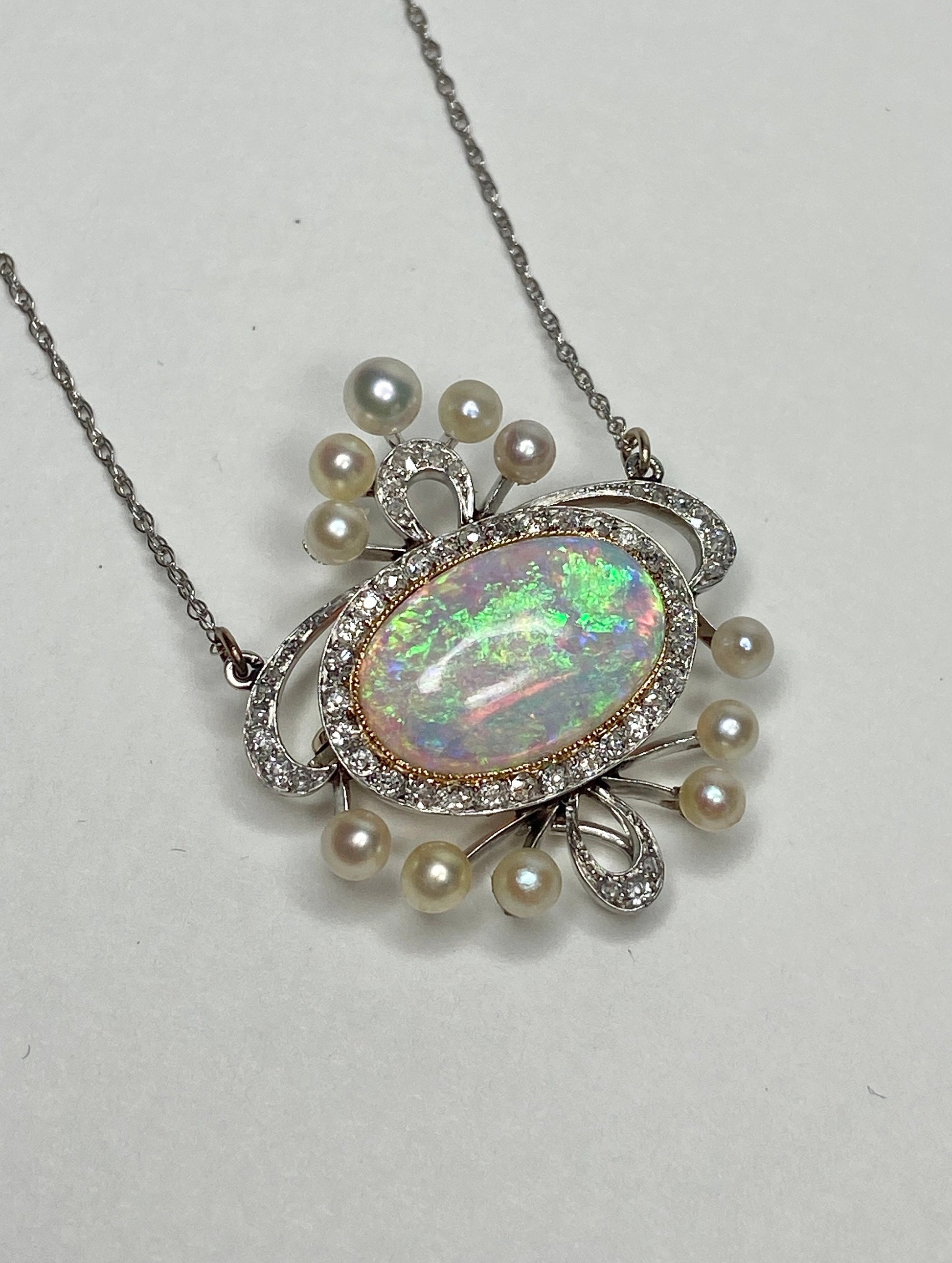 Edwardian platinum, 18k, and 14k gold necklace with opal, pearls, and diamonds.