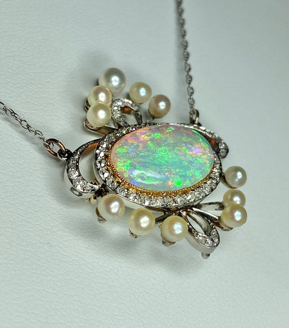 Platinum, 18k, and 14k gold pendant necklace with opal, pearls, and diamonds.