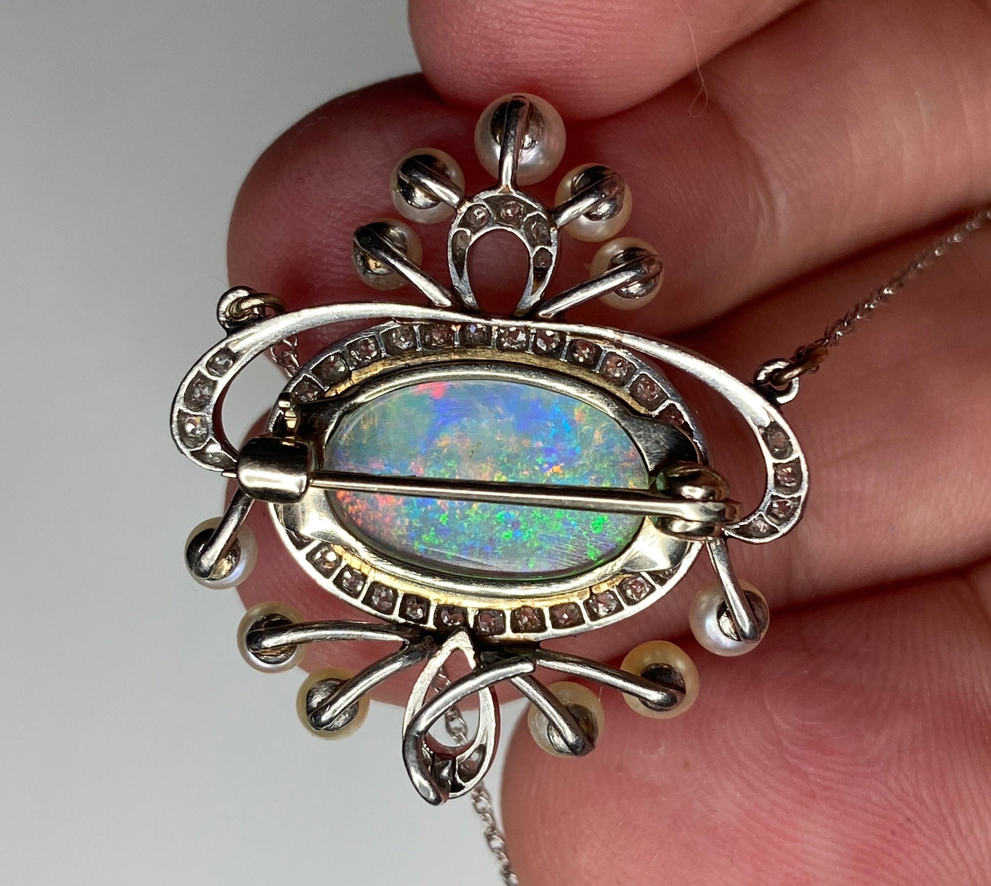 Edwardian platinum, 18k, and 14k gold brooch pendant necklace with opal, pearls, and diamonds.