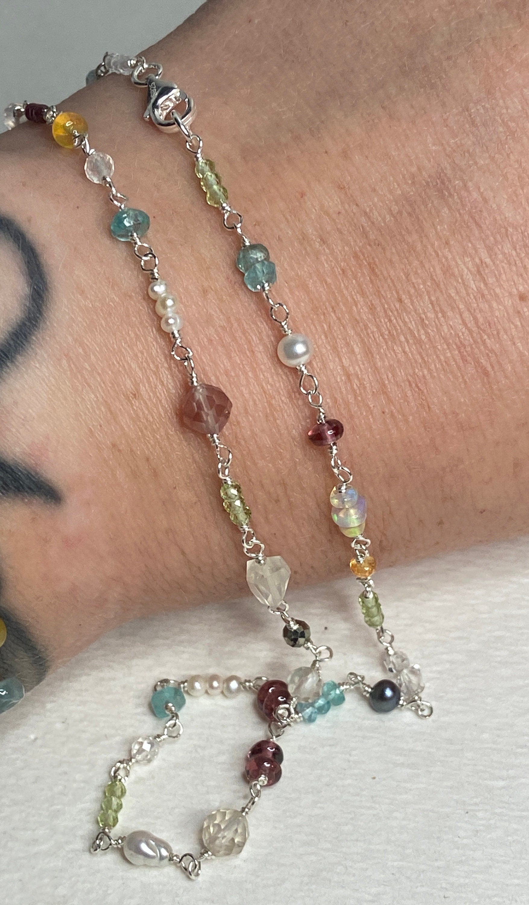 Sterling silver necklace with multi-colored gemstones and pearls.