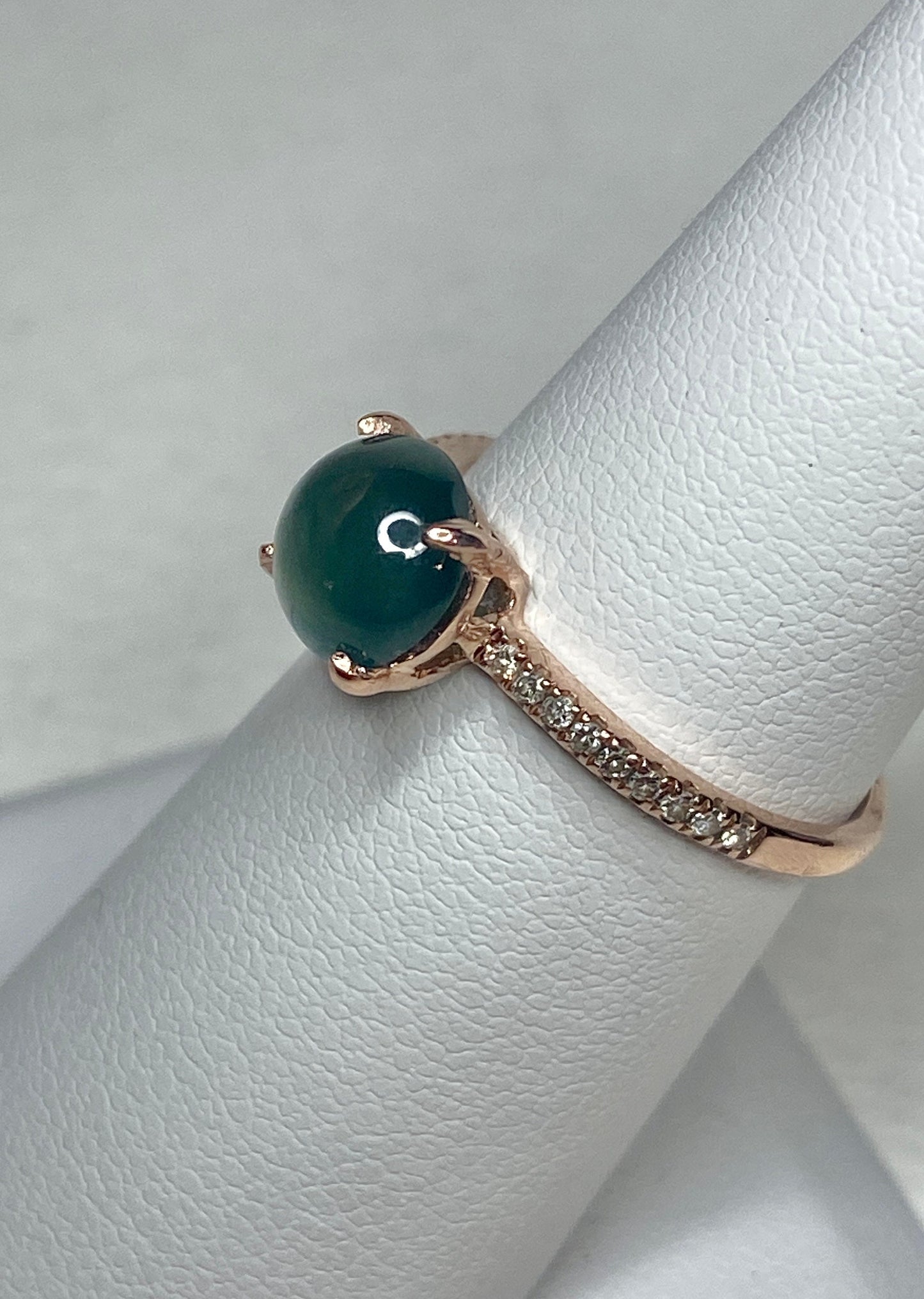A teal jadeite jade and diamond ring in 14k rose gold.