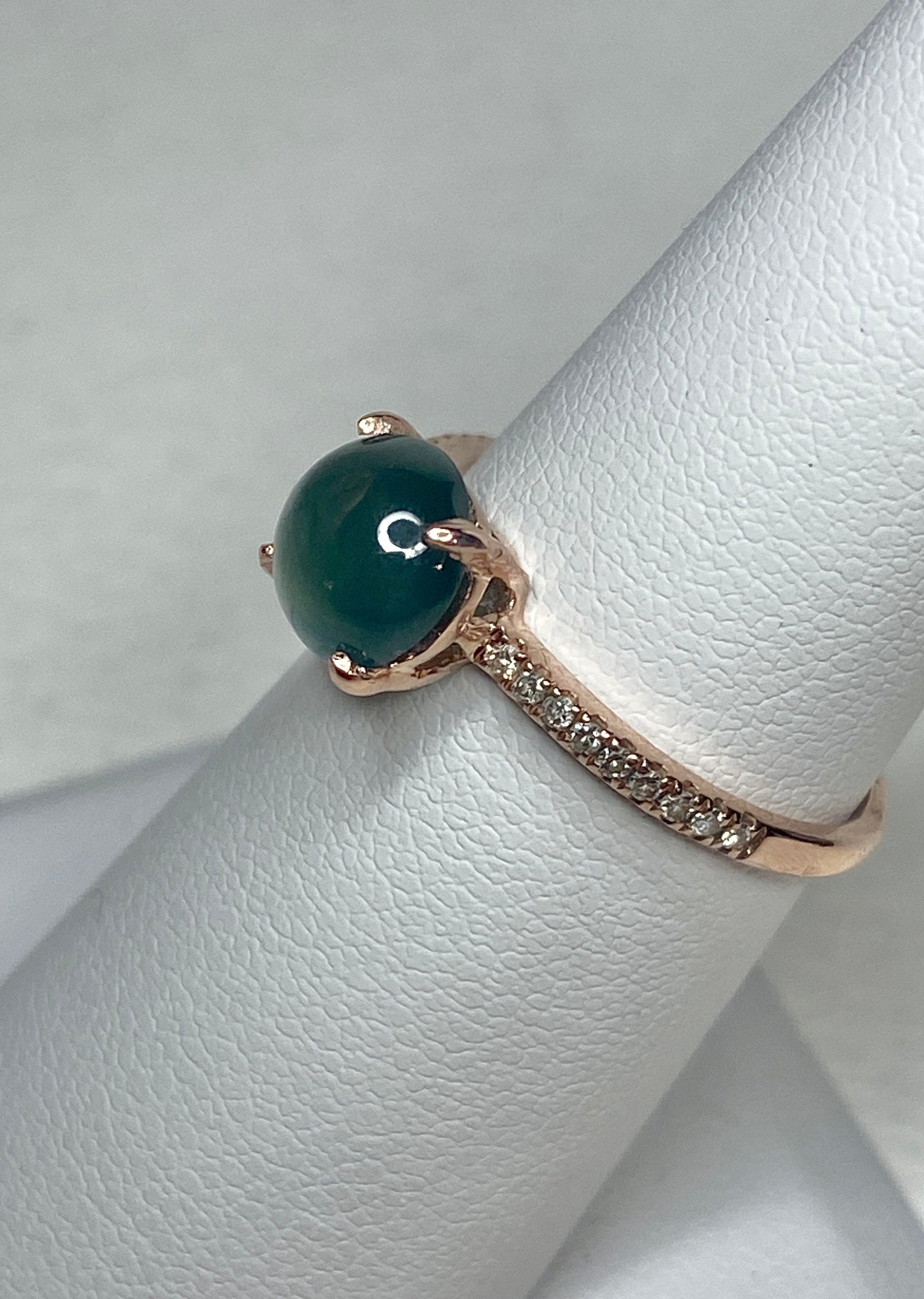 A teal jadeite jade and diamond ring in 14k rose gold.