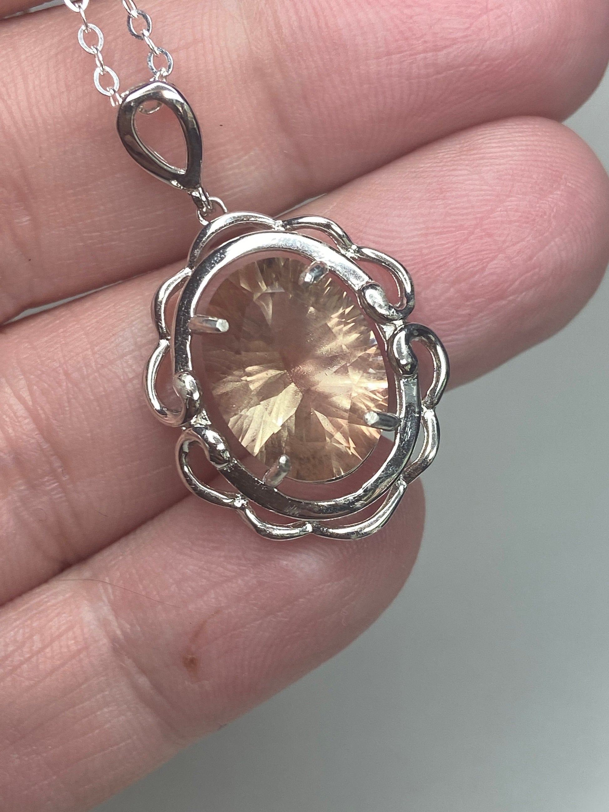 Sterling silver pendant necklace with a large oval fancy cut Oregon Sunstone.